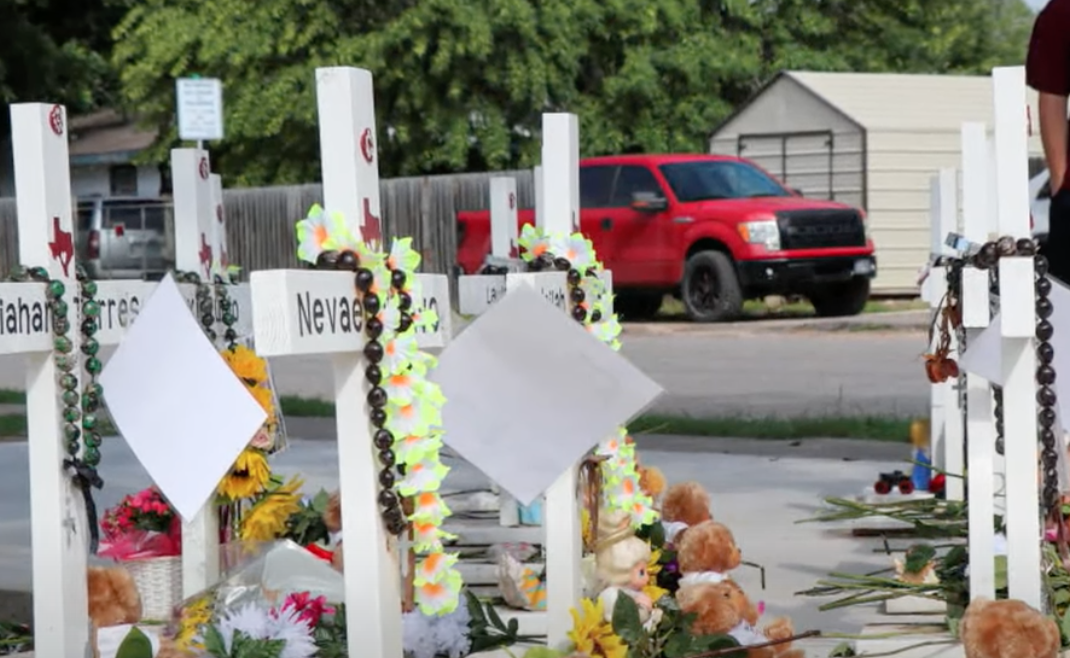 Reflecting on Uvalde: A solemn tribute at Robb Elementary School memorial, where crosses and flowers honor the lives tragically lost in the 2022 shooting, as the community mourns and seeks healing.